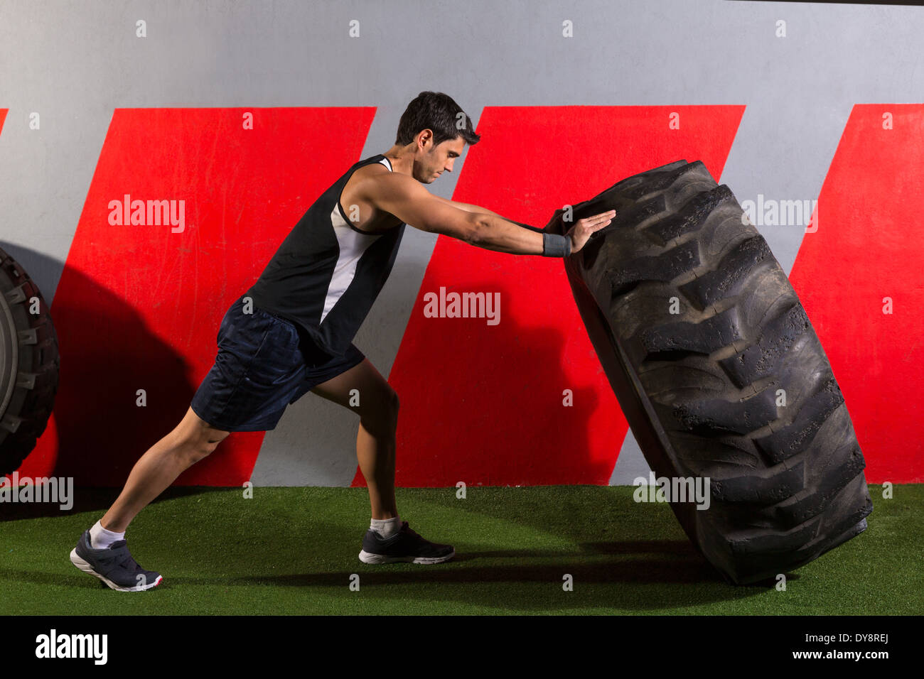 man flipping a tractor tire workout exercise at gym Stock Photo Alamy
