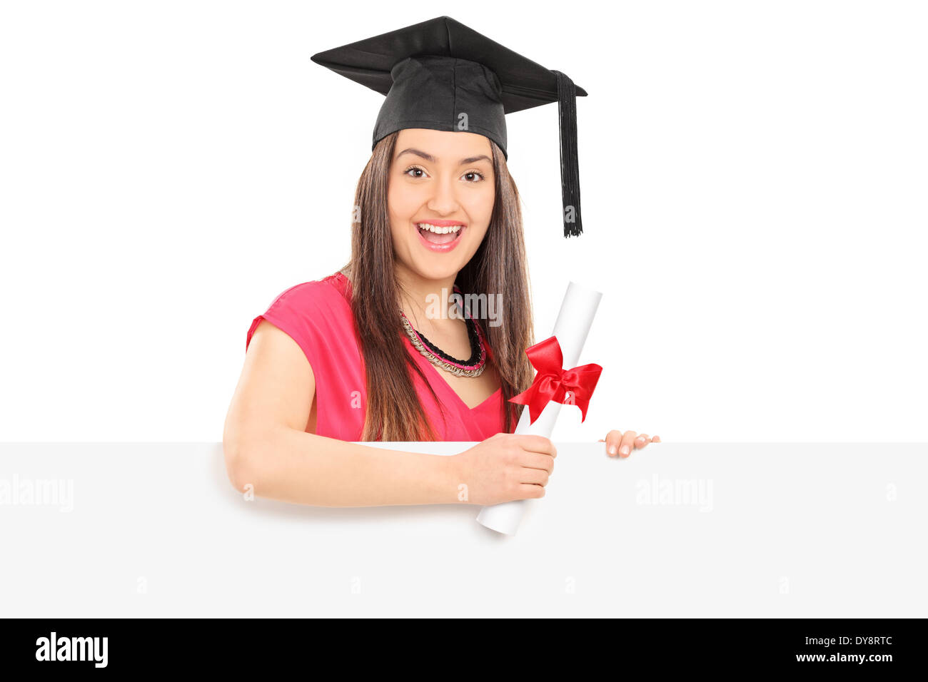 Smiling girl with diploma posing behind blank panel Stock Photo