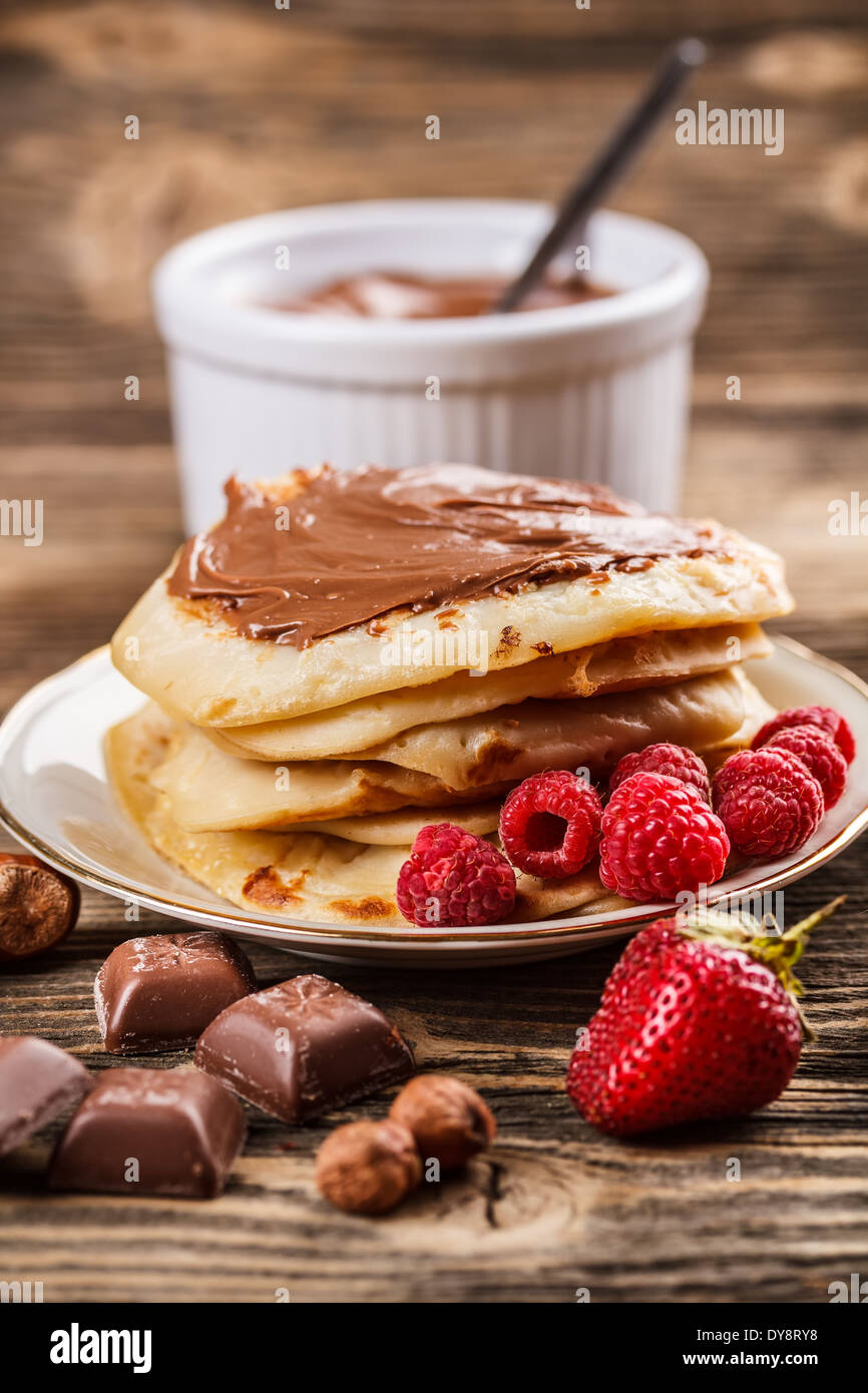 Pancakes with chocolate sauce and berries Stock Photo