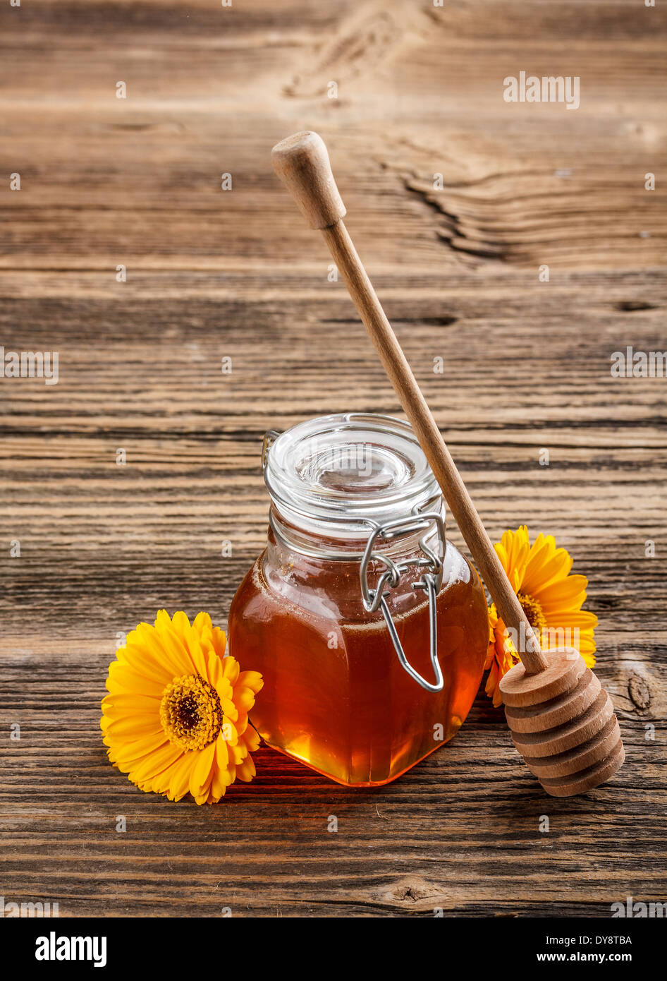 Honey with wood stick on vintage wooden background Stock Photo