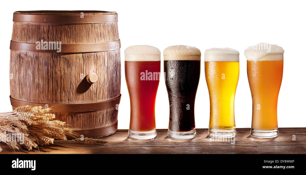 Assortment of beer glasses with a wooden barrel on a white background. Stock Photo