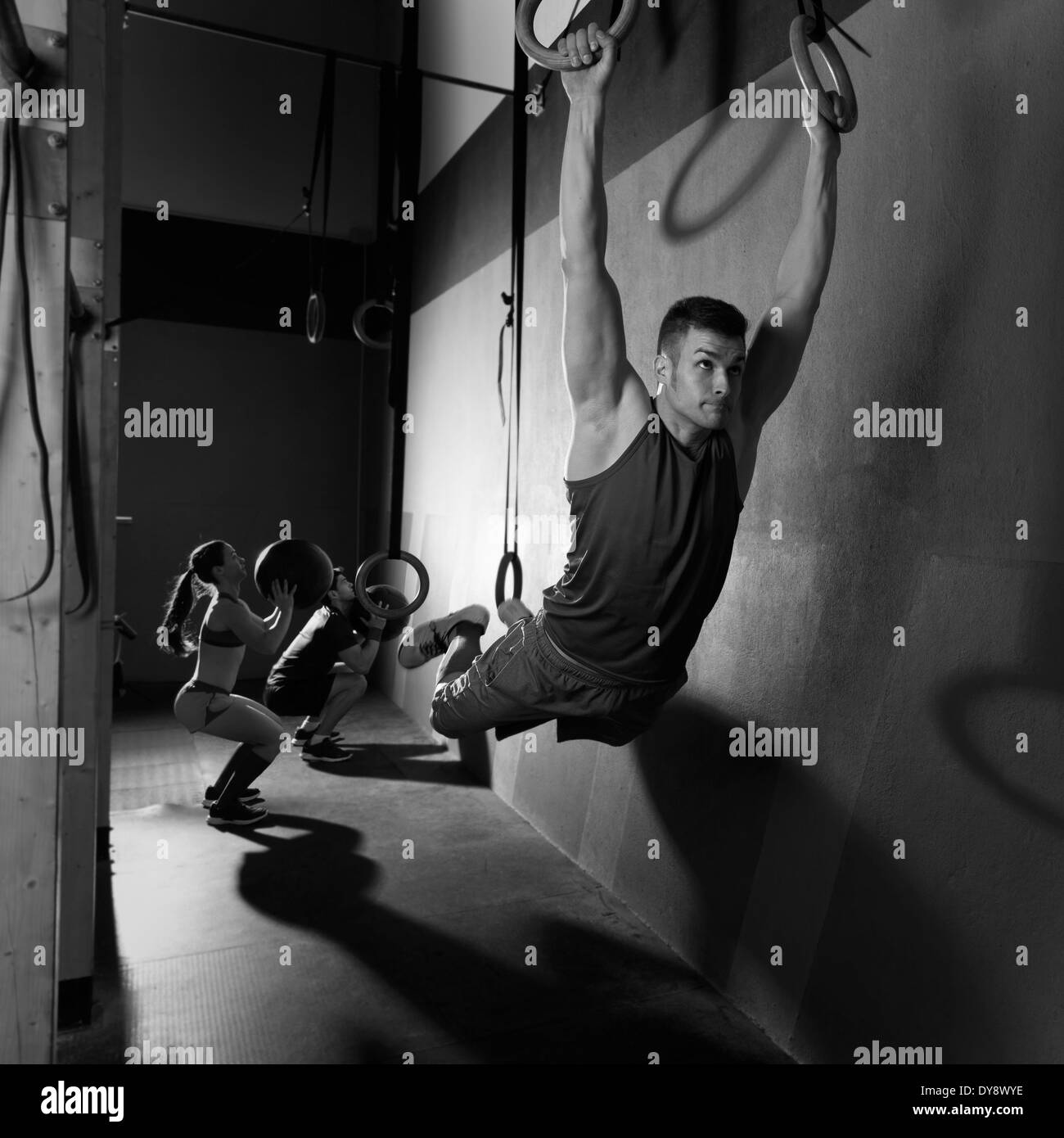 Muscle ups rings man swinging workout exercise at gym Stock Photo