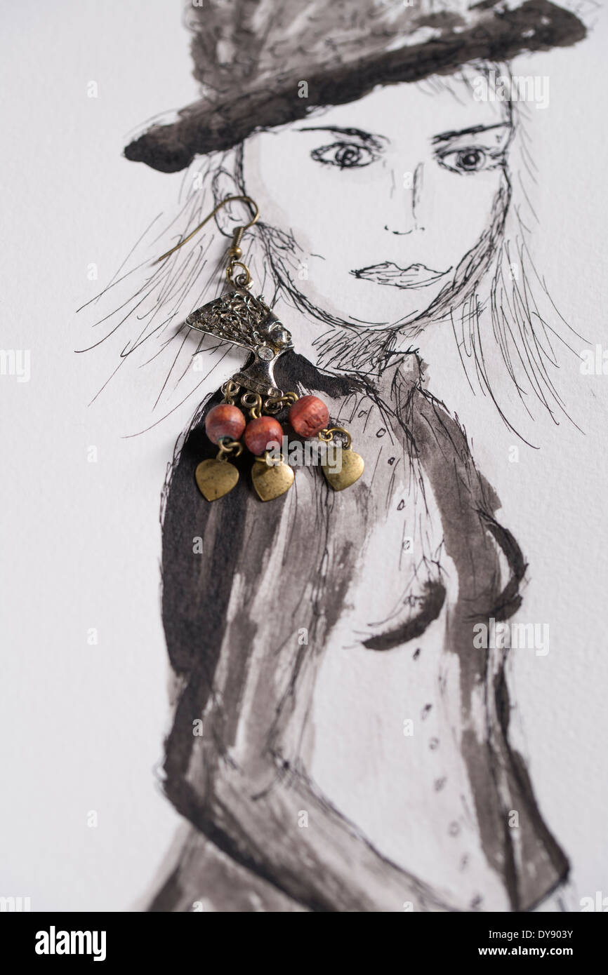 Earrings on ink drawing of a woman Stock Photo