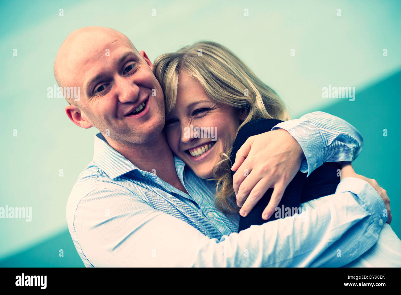 Portrait of young couple hugging Stock Photo - Alamy