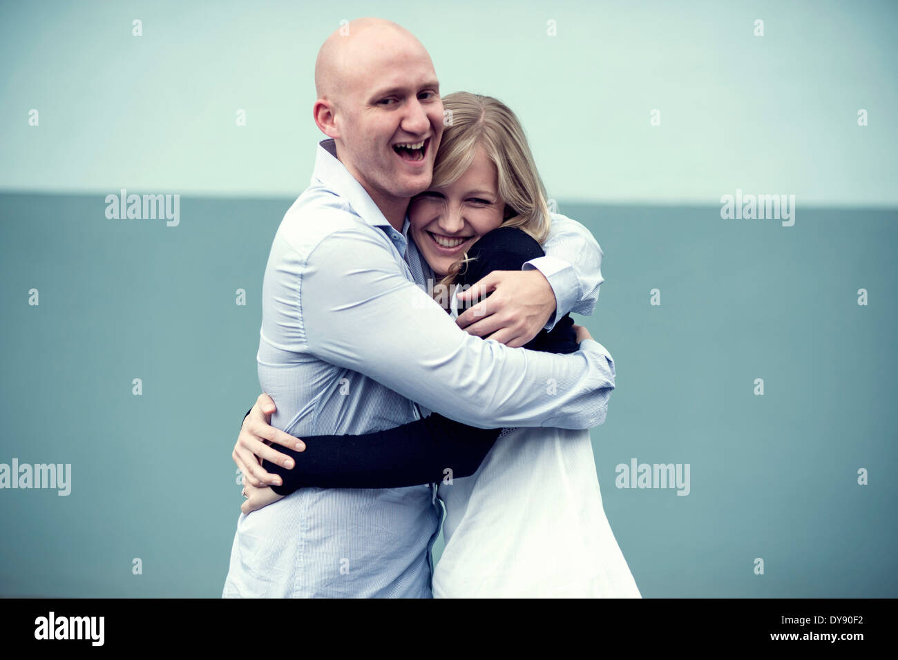 Portrait of young couple hugging Stock Photo - Alamy