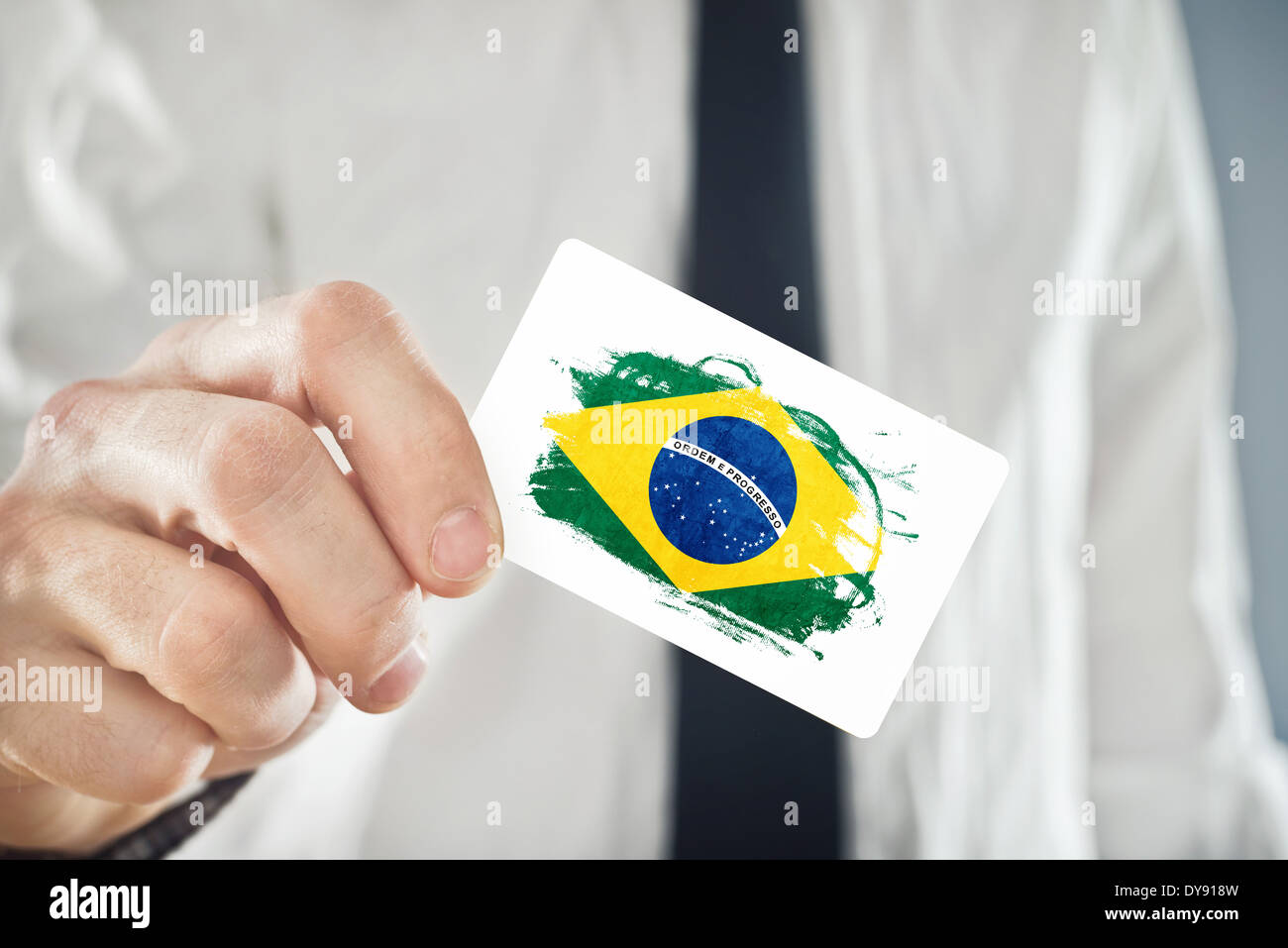 Brazilian Businessman holding business card with Brazil Flag Stock