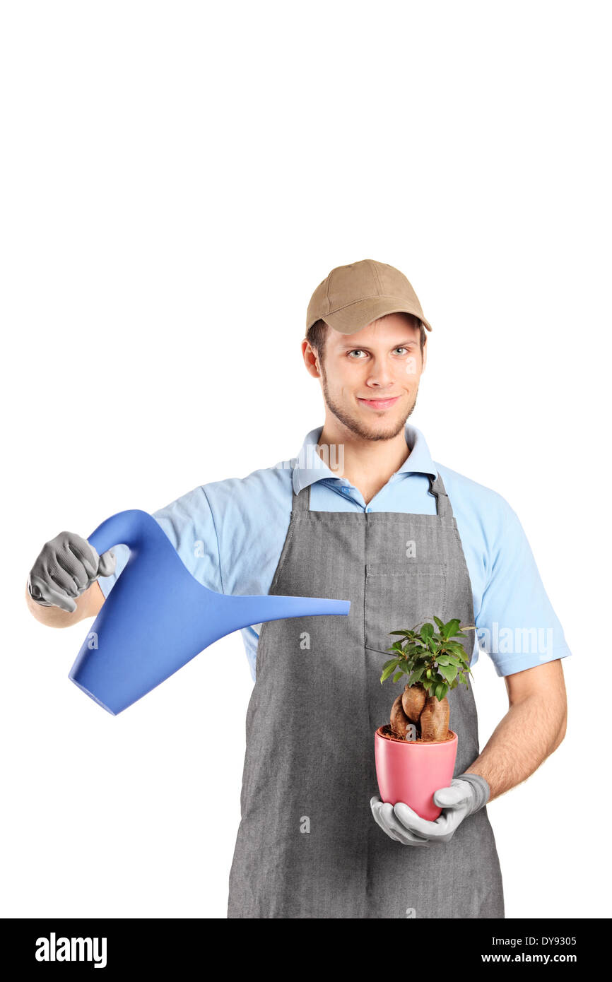 Man holding watering can and a plant = Stock Photo