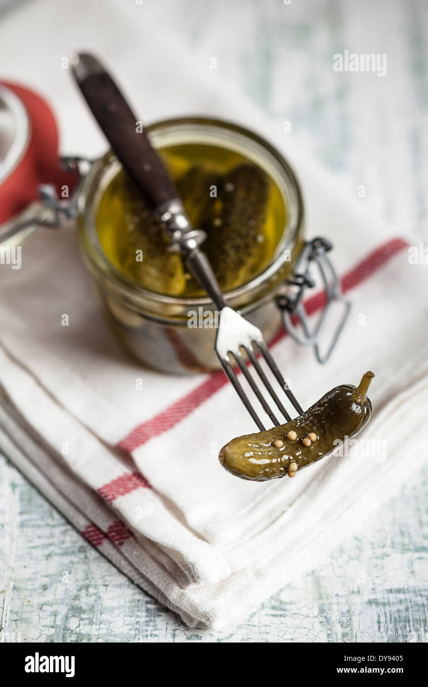 Pickled cornichons in preserving jar and fork Stock Photo Alamy