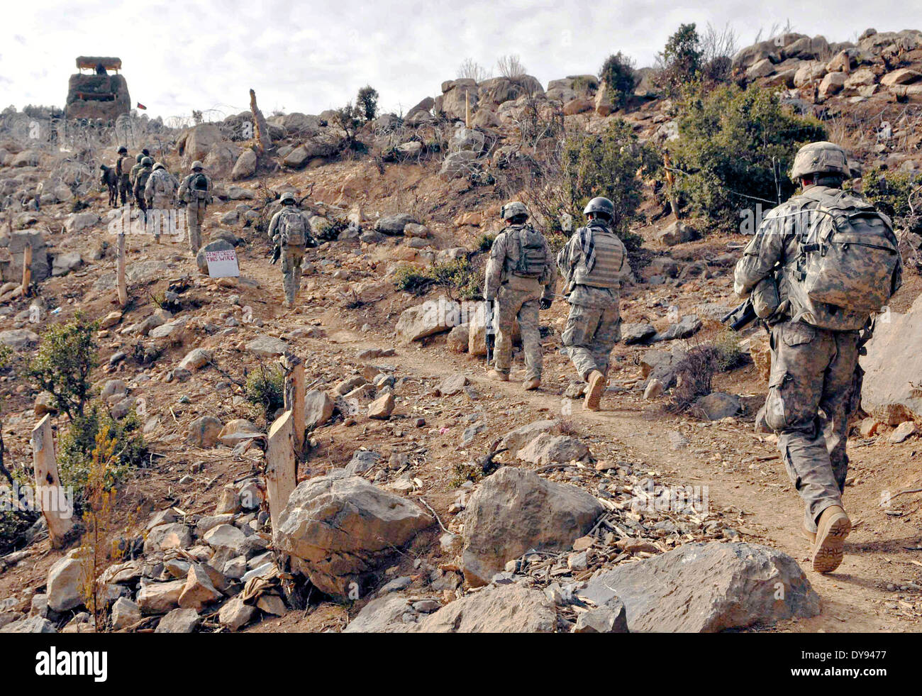 US Army soldiers return inside the wire after a security patrol to destroy a Taliban safe house December 18, 2009 in Khost province, Afghanistan. Stock Photo