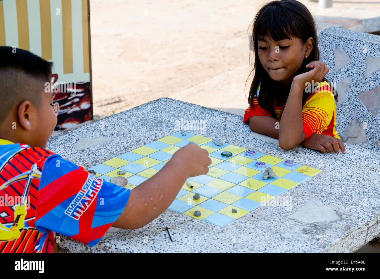 Children playing a Board Game in the Fishing Village Bang Bao on Ko Chang, Thailand Stock Photo