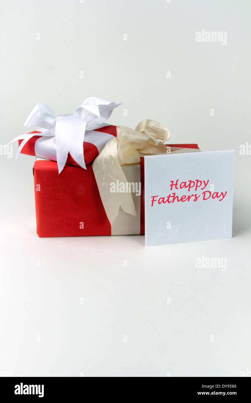 Two gift wrapped presents with bows plus a greeting card in an envelope with the message Happy Fathers Day Stock Photo