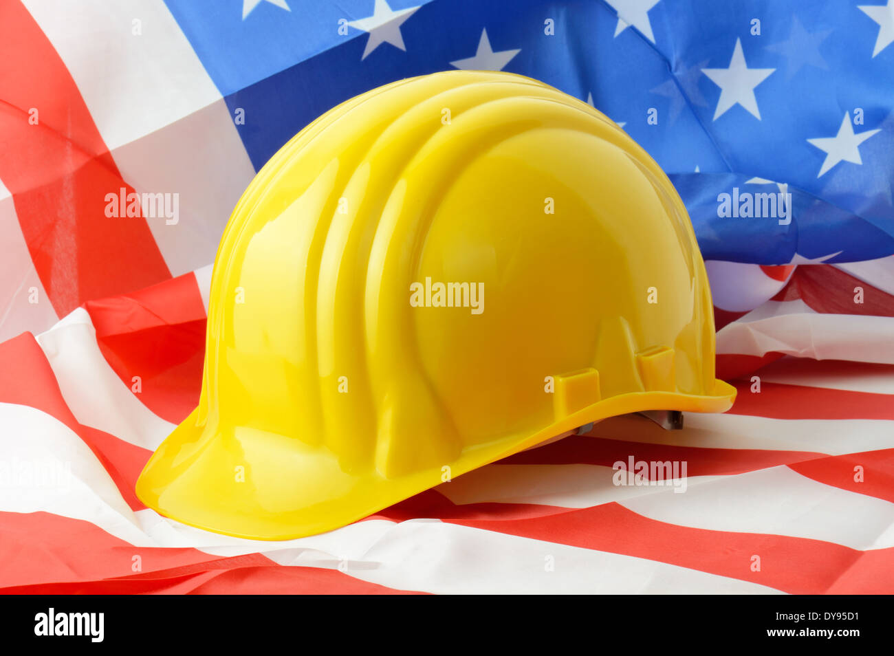 Hard hat on a american flag a symbol of construction Stock Photo