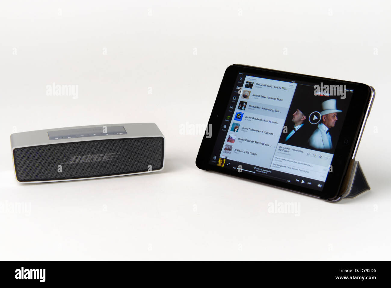 Apple iPad mini running a music app a Bose portable bluetooth speaker Stock Photo - Alamy