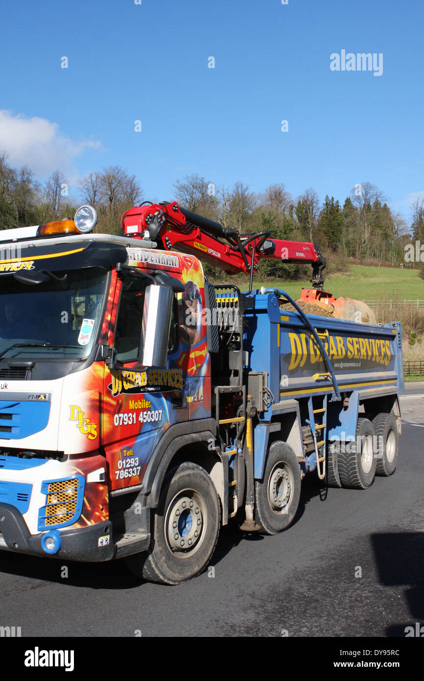 A DJ Grab Services truck traveling around a roundabout in Coulsdon, Surrey, England Stock Photo