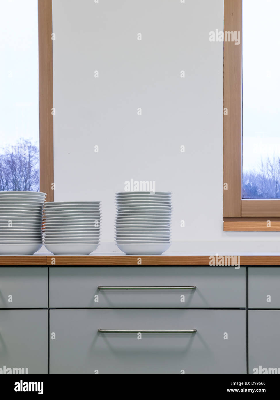Dishware on kitchen cupboard Stock Photo
