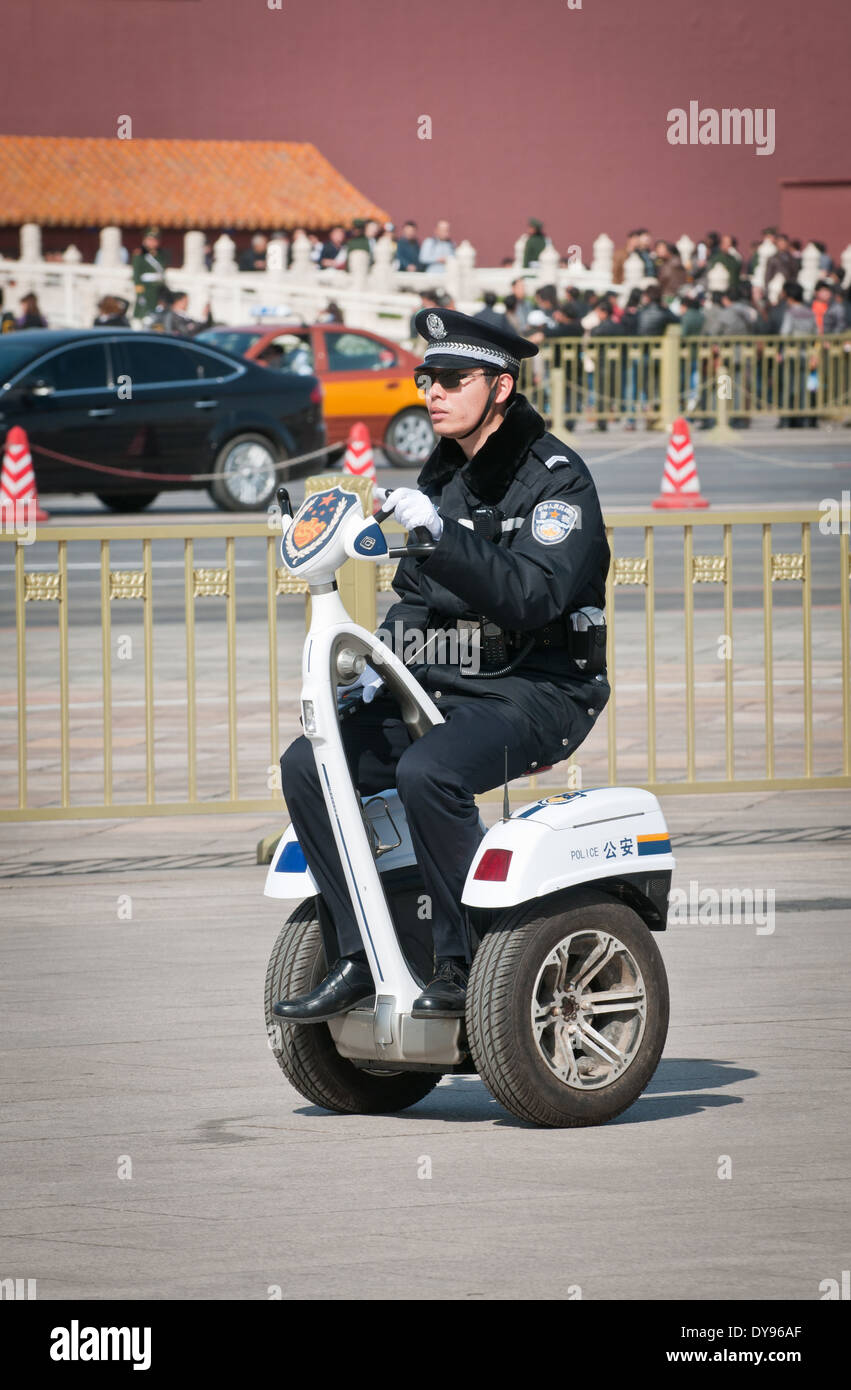 Chinese policeman on FREEYOYO segway G3 cargo on patrol at Tiananmen Square, Beijing, China Stock Photo