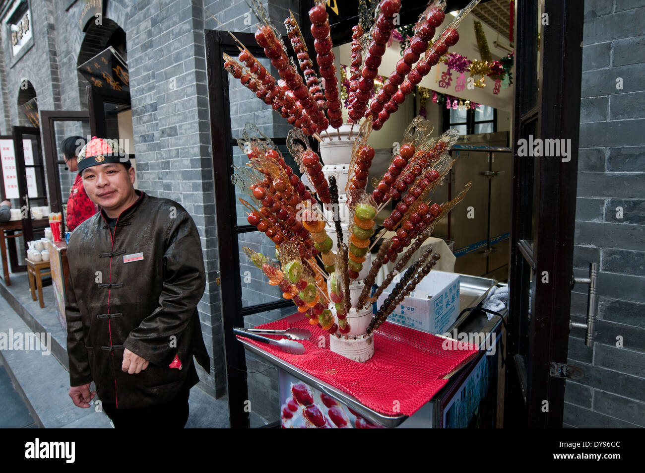 candied fruits (Tanghulu) at one of the renovated perpendicular street to famous Qianmen Dajie, Beijing, China Stock Photo