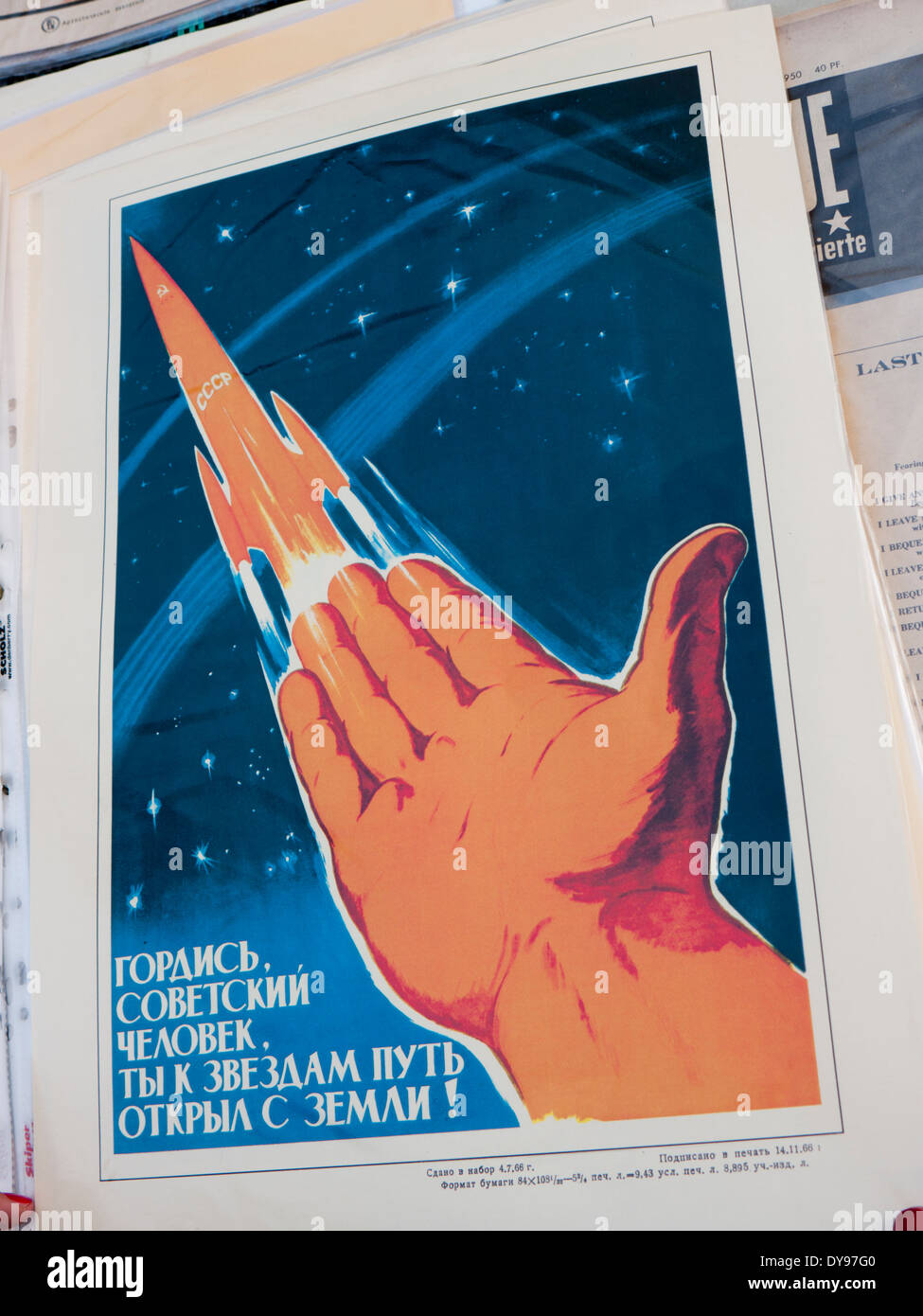An old Russian propaganda poster promoting space race technology for sale at the flea market in Kiev Ukraine Stock Photo
