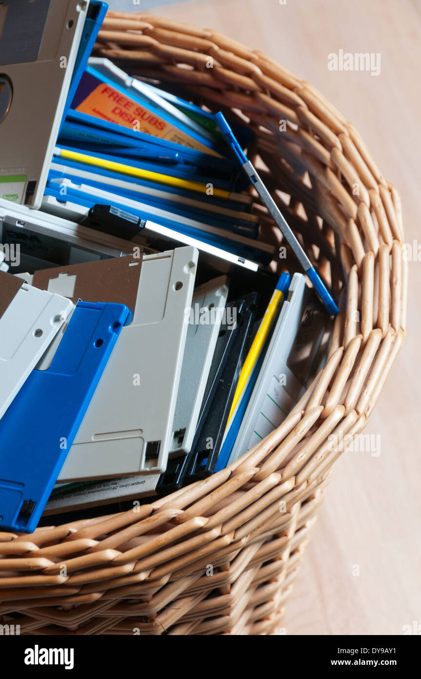 Old 3.5' computer disks thrown away in a waste paper basket. Stock Photo