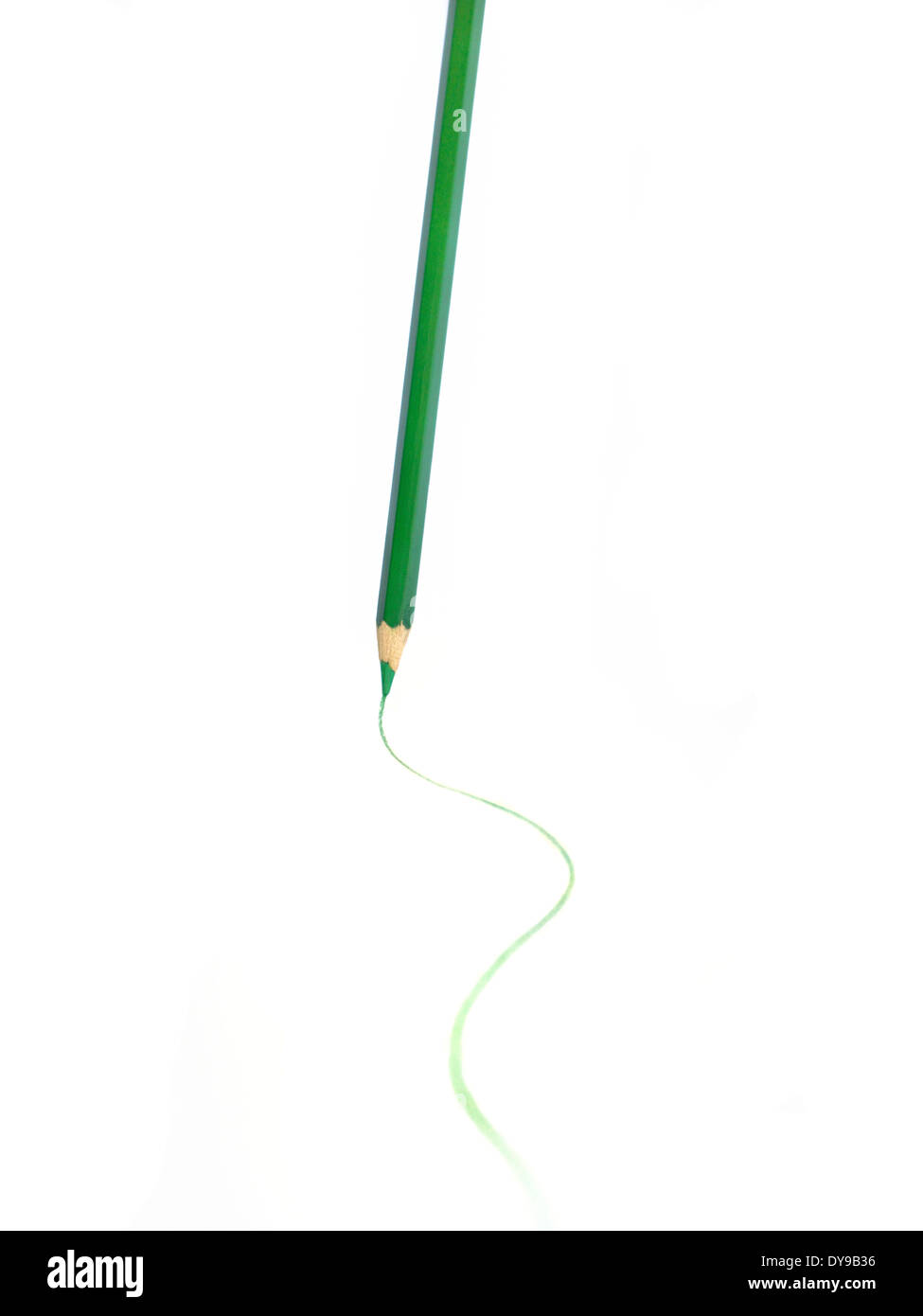 Green pencil marking a paper on white background. Stock Photo