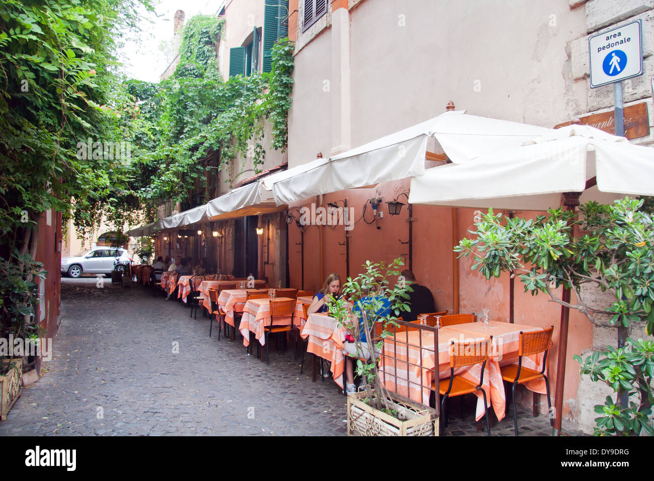 Family having a dinner in a street restaurant in Trastevere; Rome Stock Photo