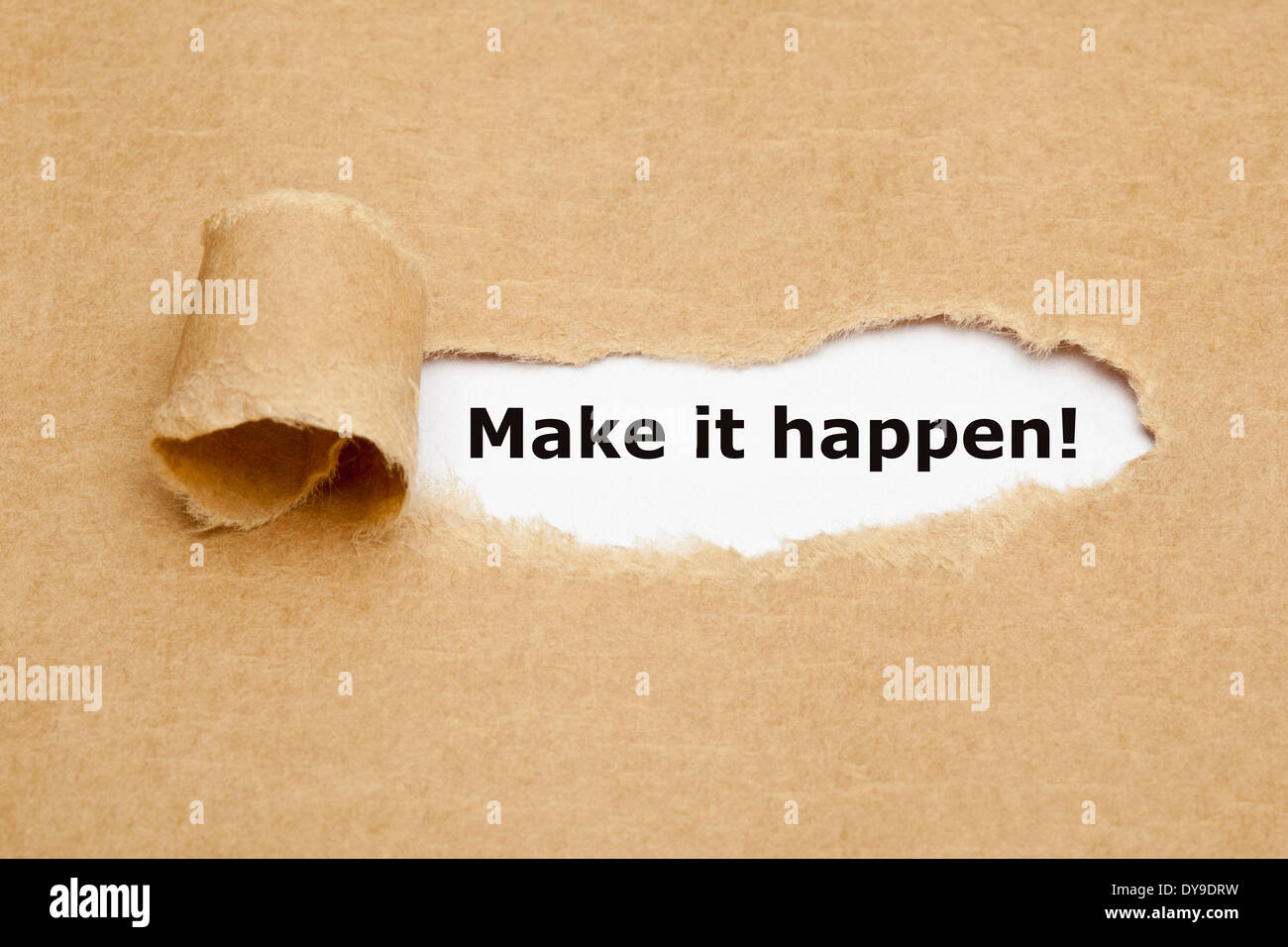 Make it happen! appearing behind torn brown paper Stock Photo Alamy