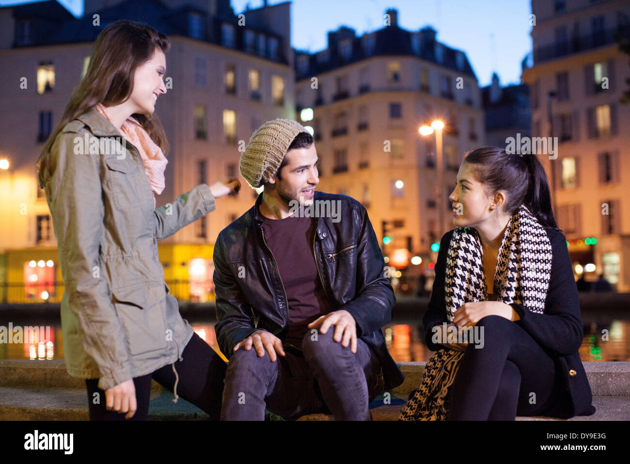 Friends hanging out together outdoors at night Stock Photo - Alamy