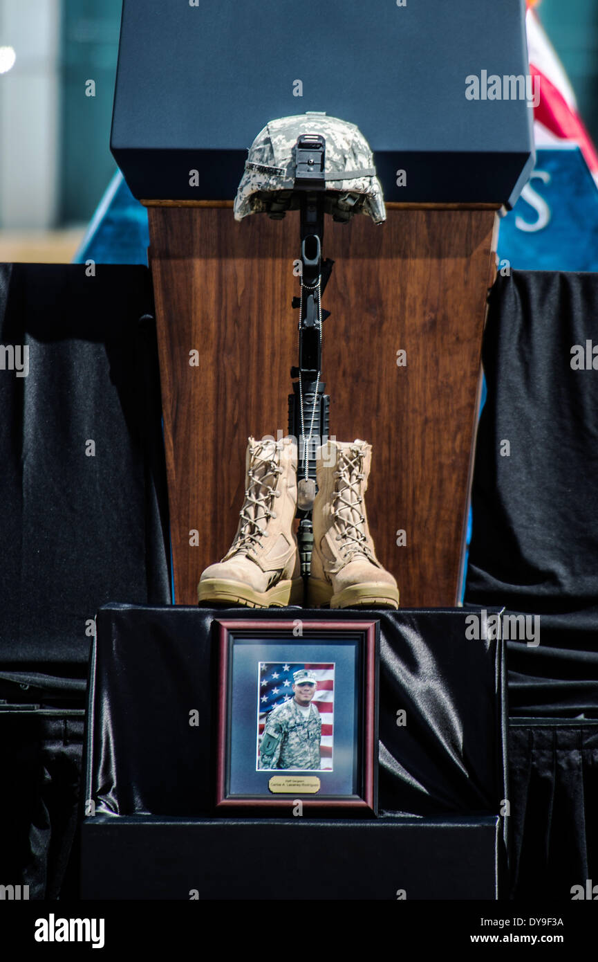 A  Battlefield Cross of boots, helmet and rifle for fallen soldiers during a memorial ceremony for the three soldiers killed and 16 injured in a gun rampage by a fellow soldier April 9, 2014 in Fort Hood, Texas. Stock Photo