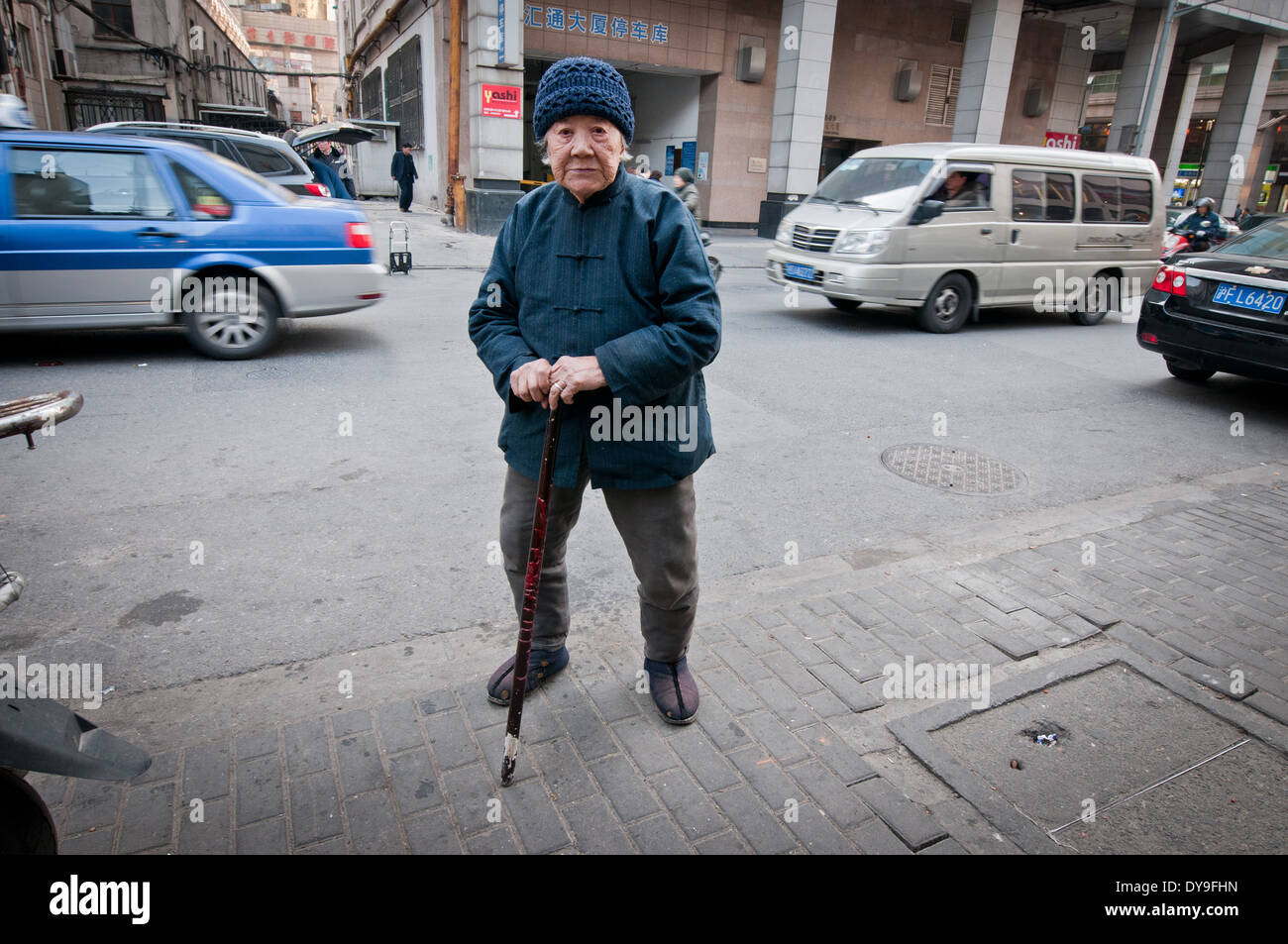 Old Chinese woman on street in Shanghai, China Stock Photo