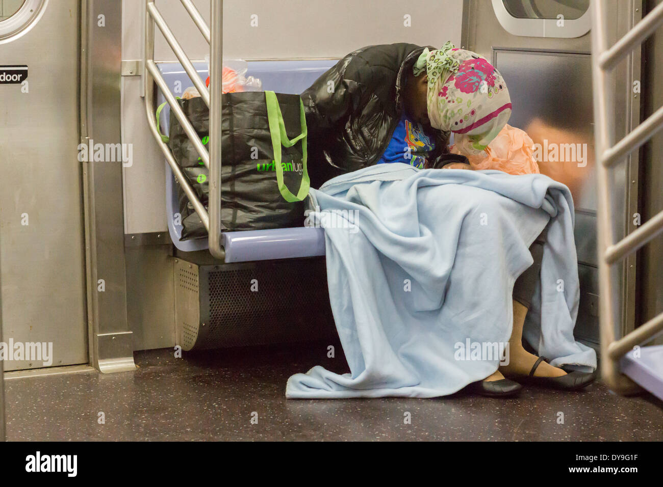 Un-domiciled individual sleeps in the subway in New York on Tuesday, April 8, 2014. (© Richard B. Levine) Stock Photo
