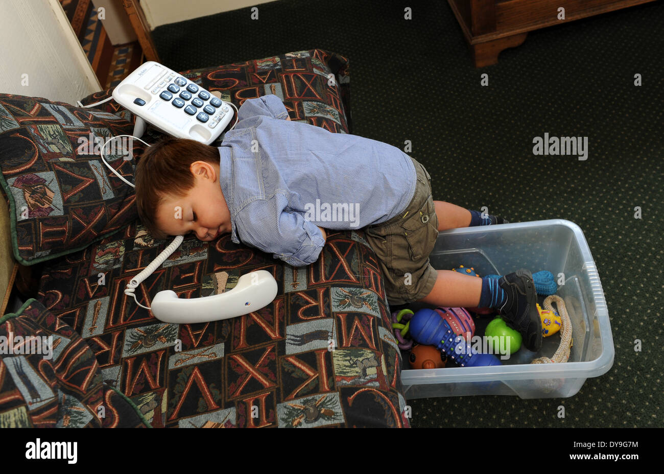 Boy child toddler asleep with phone Uk Stock Photo