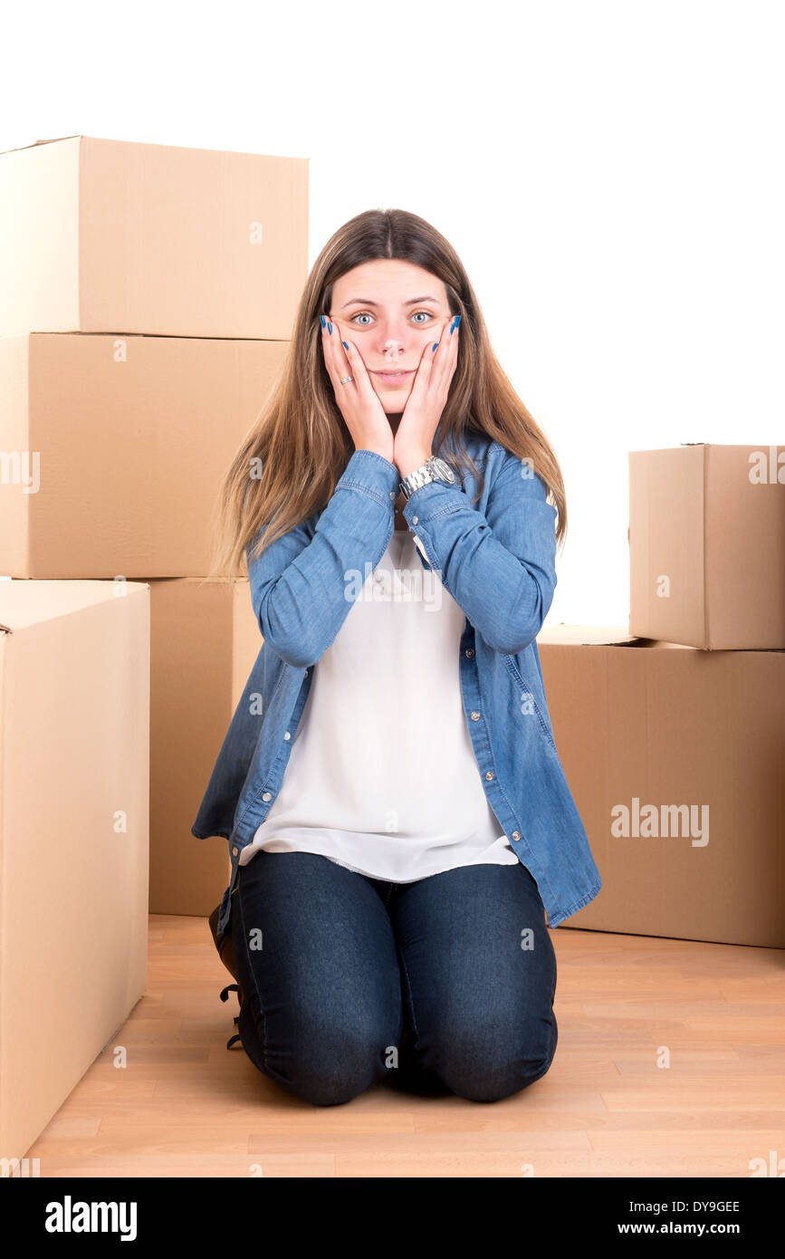 Tired girl with cardboard boxes unpacking in new home Stock Photo