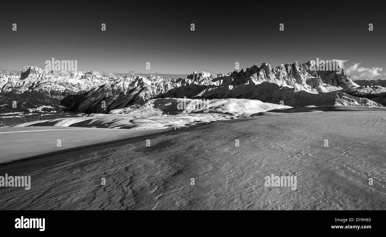 The Dolomites in winter. The Pale di San Martino and Dolomiti peaks. View from Col Margherita mount. Landscape in black white. Italian Alps. Stock Photo