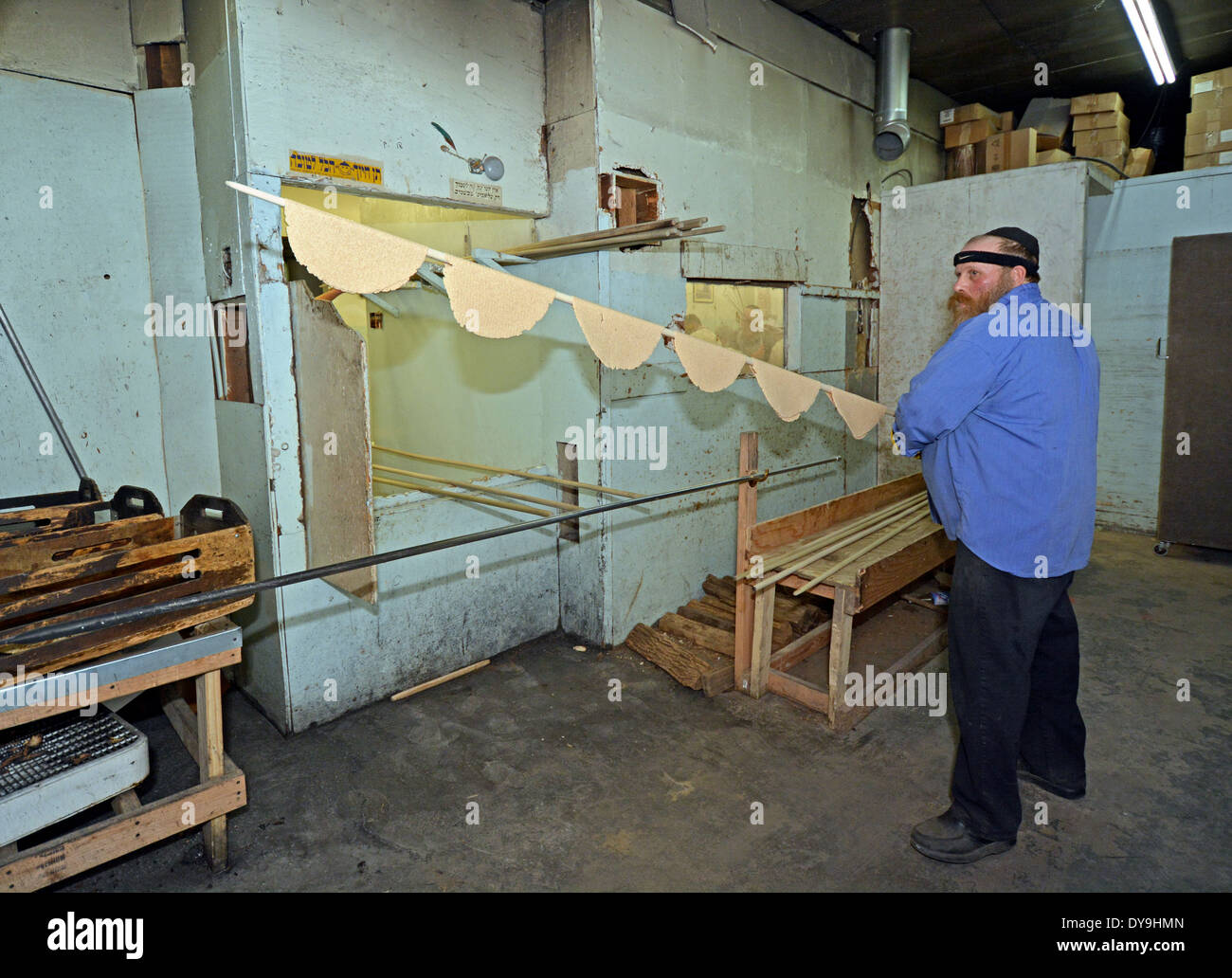 A religious Jewish man putting matzoh into the oven at the Borough Park Matzah Bakery in Brooklyn, New York Stock Photo