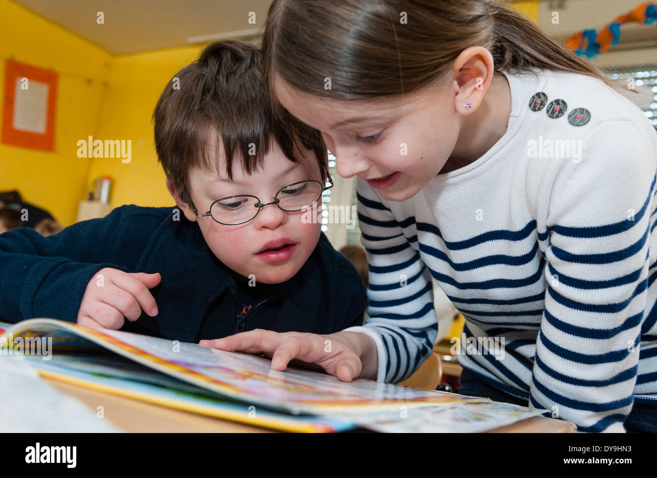 Non-disabled and disabled pupils (in this case a boy suffering from Down's syndrome) learn together in the same class. Stock Photo