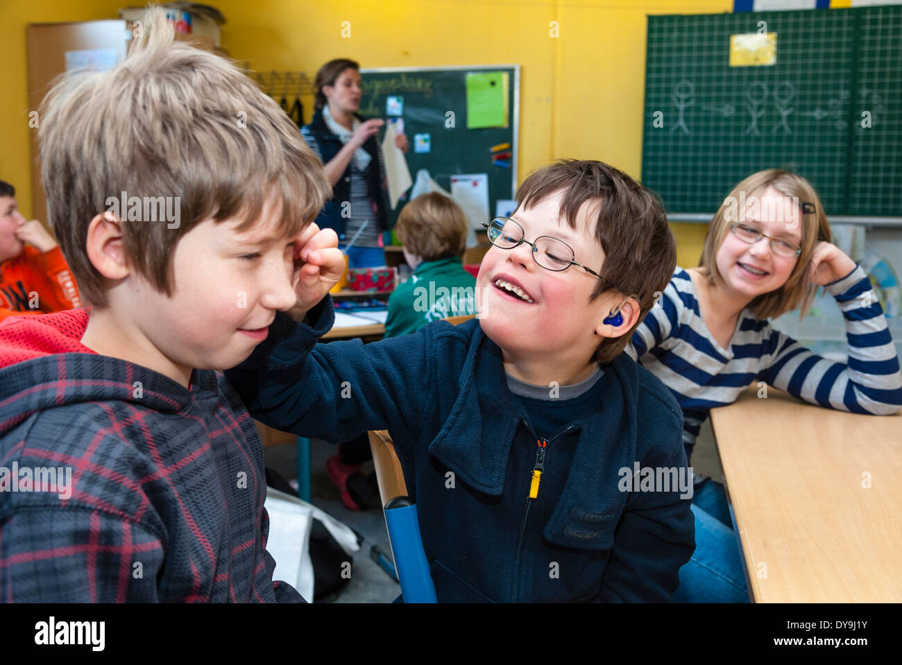 Non-disabled and disabled pupils (in this case a boy suffering from Down's syndrome) learn together in the same class. Stock Photo