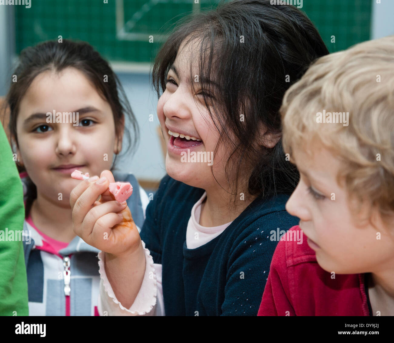 Non-disabled and disabled pupils (in this case a girl suffering from Down's syndrome) learn together in the same classroom. Stock Photo