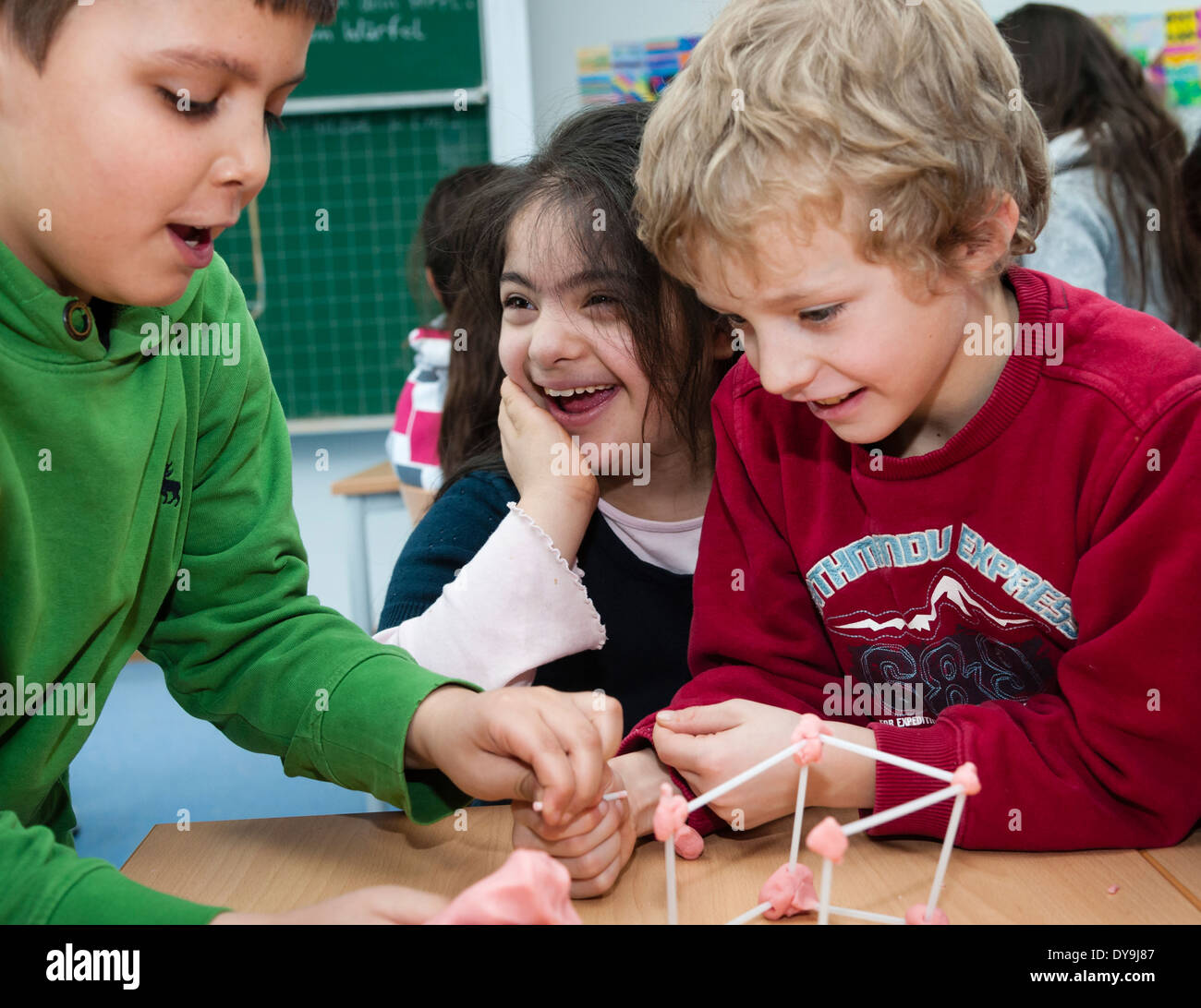 Non-disabled and disabled pupils (in this case a girl suffering from Down's syndrome) learn together in the same classroom. Stock Photo