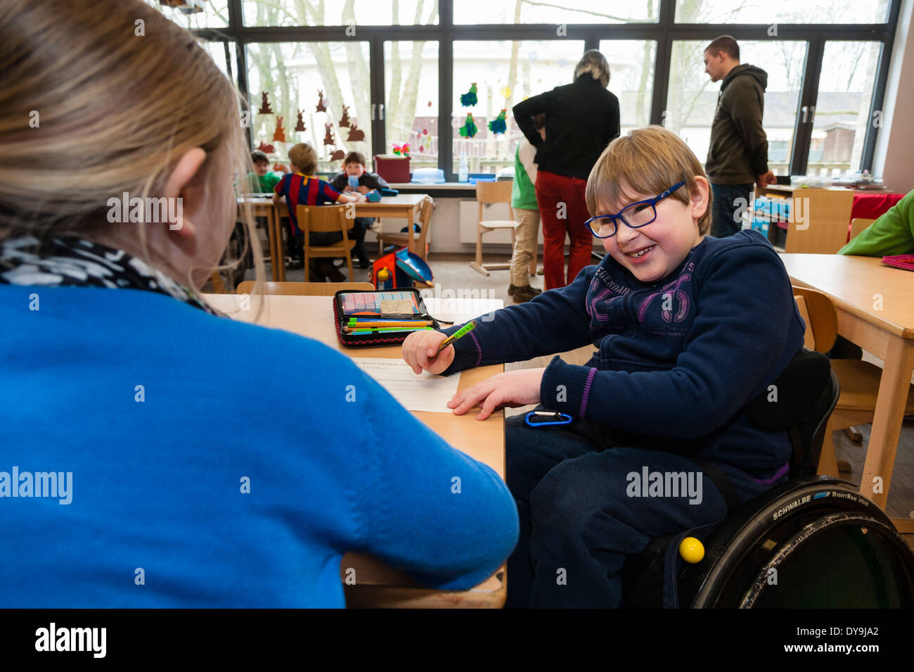 Non-disabled and disabled students (in this case a boy in a wheel chair) learn together in the same class in a primary school. Stock Photo