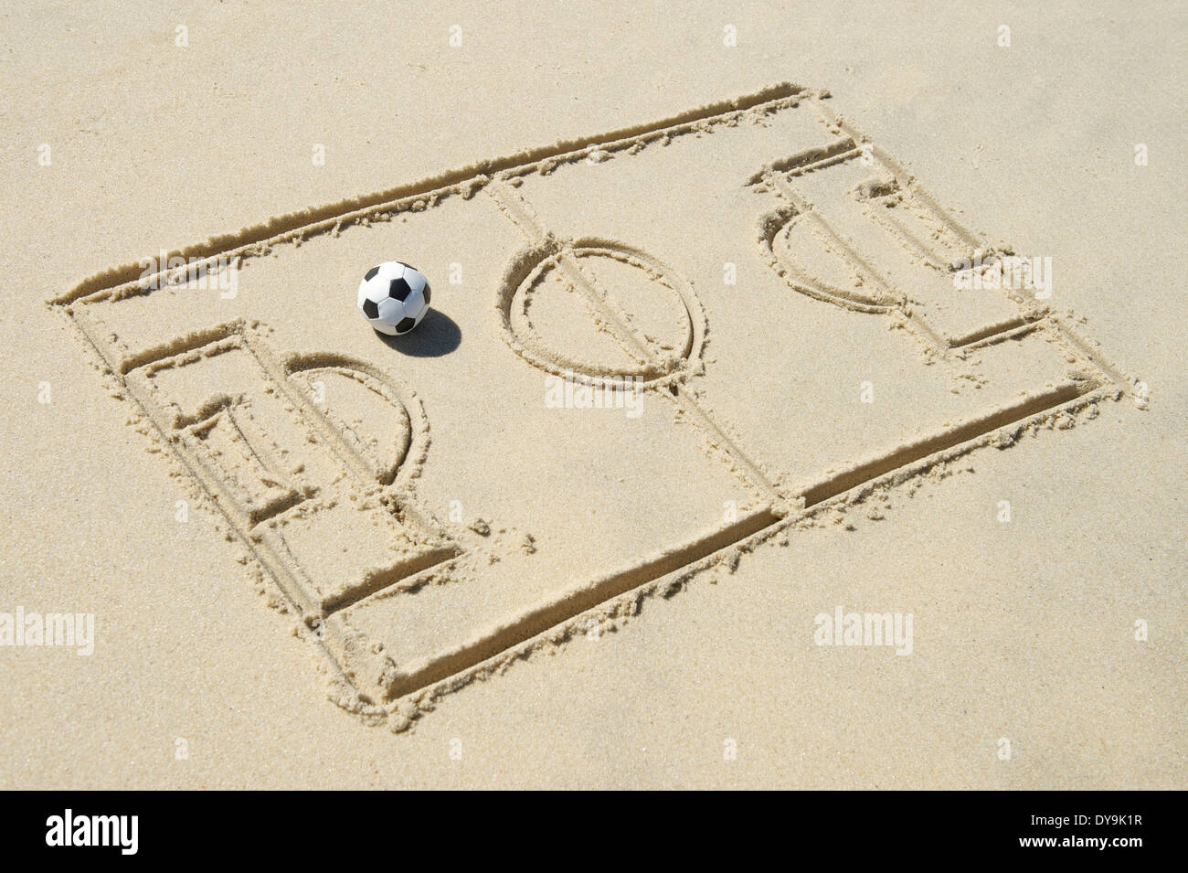 Simple line drawing of football pitch with soccer ball in sand on Brazilian beach Stock Photo