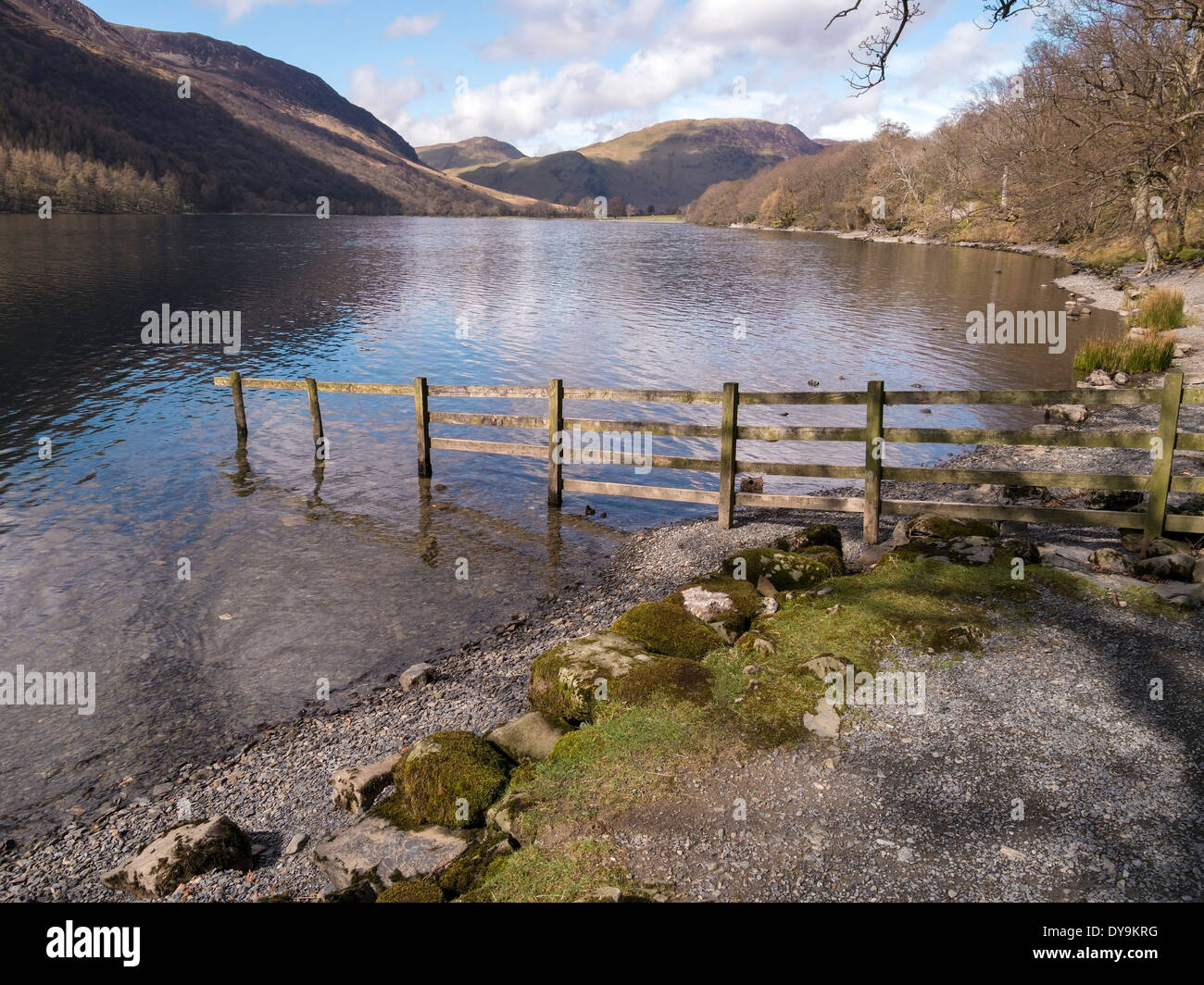 Fence on shore of calm waters of Lake Buttermere in English Lake District National Park, Cumbria, England, UK Stock Photo