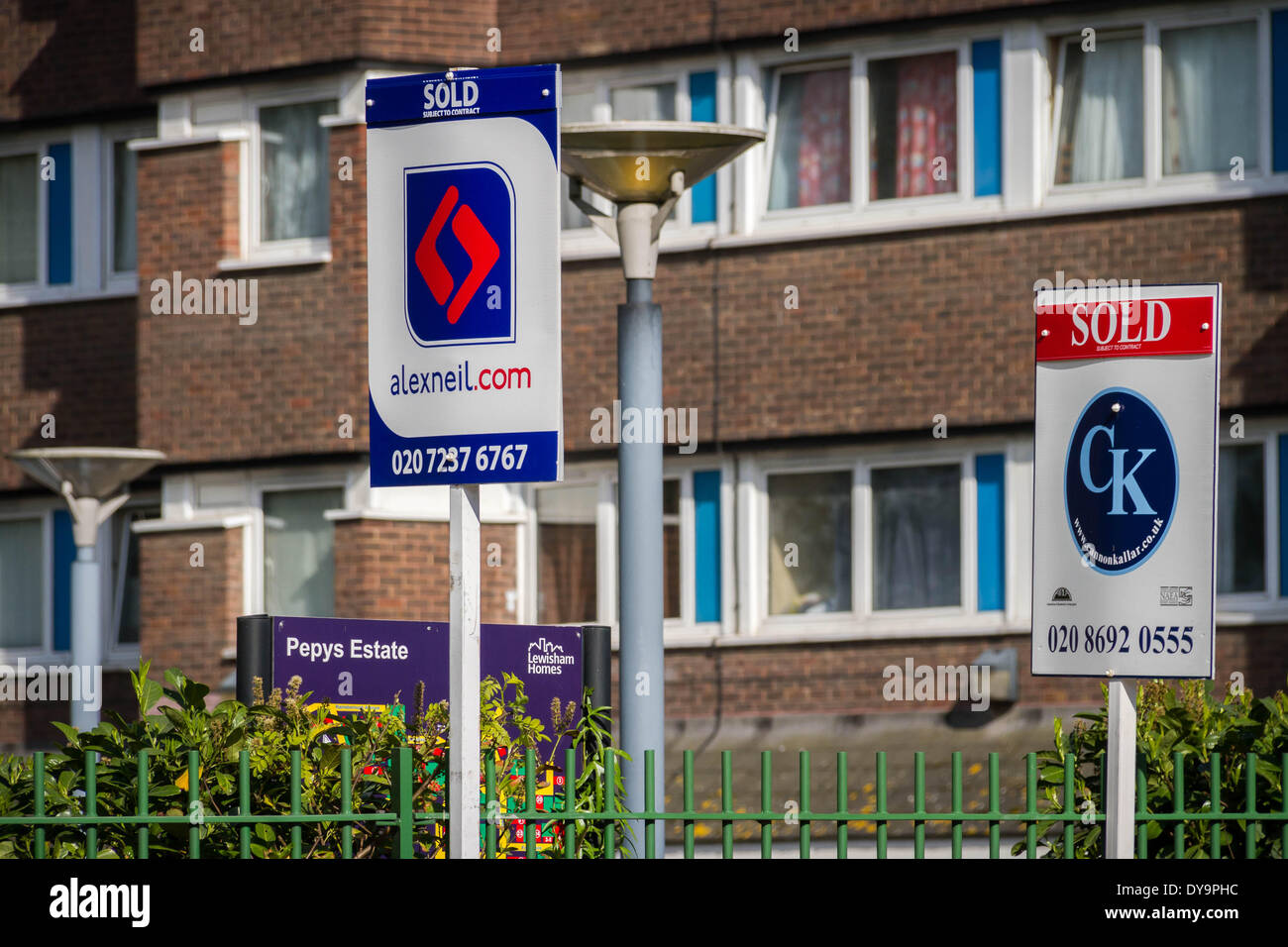 Estate agents boards advertising sale or rental seen outside London property, UK. Stock Photo