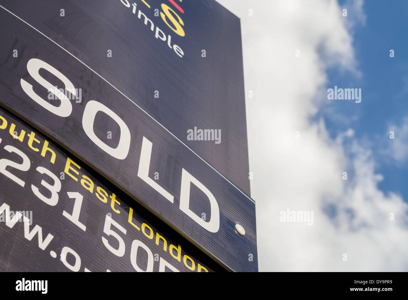 Estate agents boards advertising sale or rental seen outside London property, UK. Stock Photo