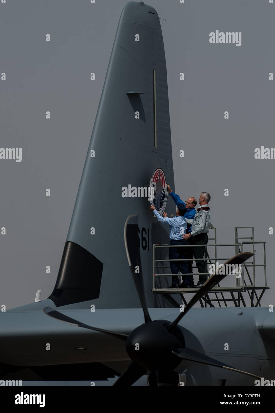 (140411) -- NEVATIM AIR BASE (ISRAEL), April 11, 2014 (Xinhua) -- Israeli Defense Minister Moshe Ya'alon (C) pastes the 'Elephants' squadron sign on the tail of a Super Hercules C-130J at Nevatim Air Base near Beer Sheva, southern Israel, on April 9, 2014. The Super Hercules C-130J was inaugurated into the ranks of the Israeli Air Force (IAF) on Wednesday. Plane number 661, which touched ground at the Nevatim Air Base after a 12-hour flight from the United States, is the first of three J-model aircrafts that Israel ordered from the Lockheed Martin Corporation.Equipped with Israeli-made electro Stock Photo