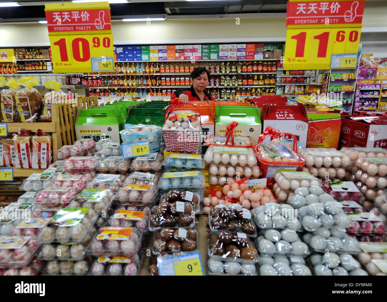 Shijiazhuang, China's Hebei Province. 9th Apr, 2014. A staff member from a supermarket sorts eggs in Shijiazhuang, capital of north China's Hebei Province, April 9, 2014. China's consumer price index (CPI), a main gauge of inflation, increased 2.4 percent year on year in March, up from 2 percent in the previous month, official data showed on April 11. © Mou Yu/Xinhua/Alamy Live News Stock Photo
