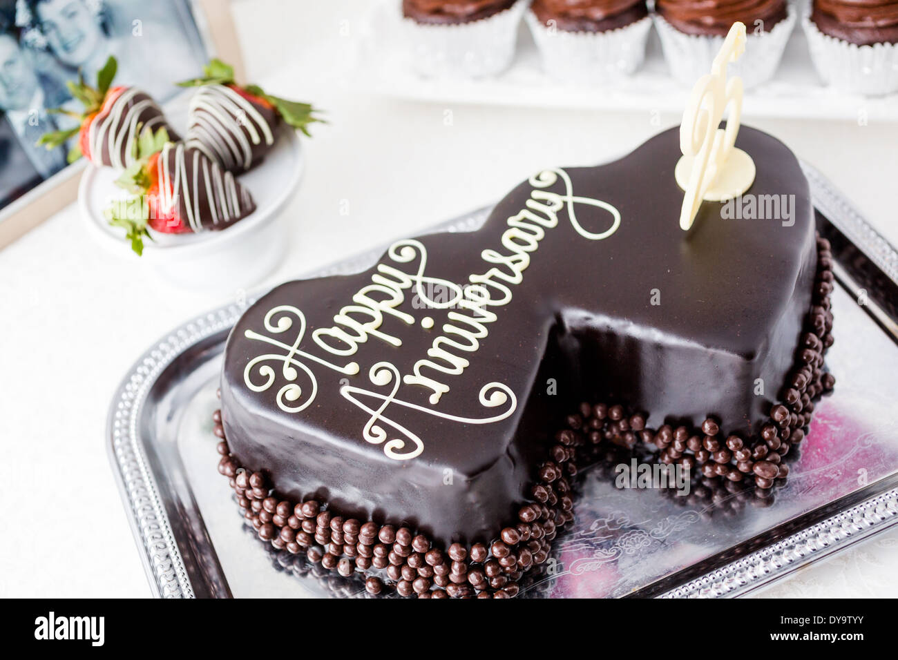 Celebrating wedding anniversary with heart shape chocolate cake ...