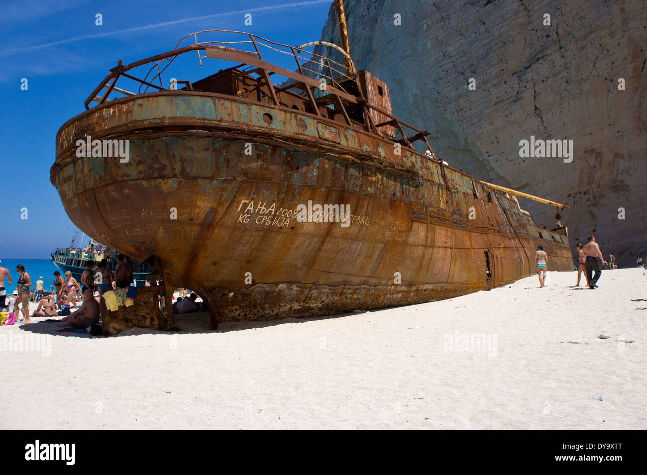 Wreck on shipwreck beach with tourist and tourboat, Island Zakynthos, Greece Stock Photo