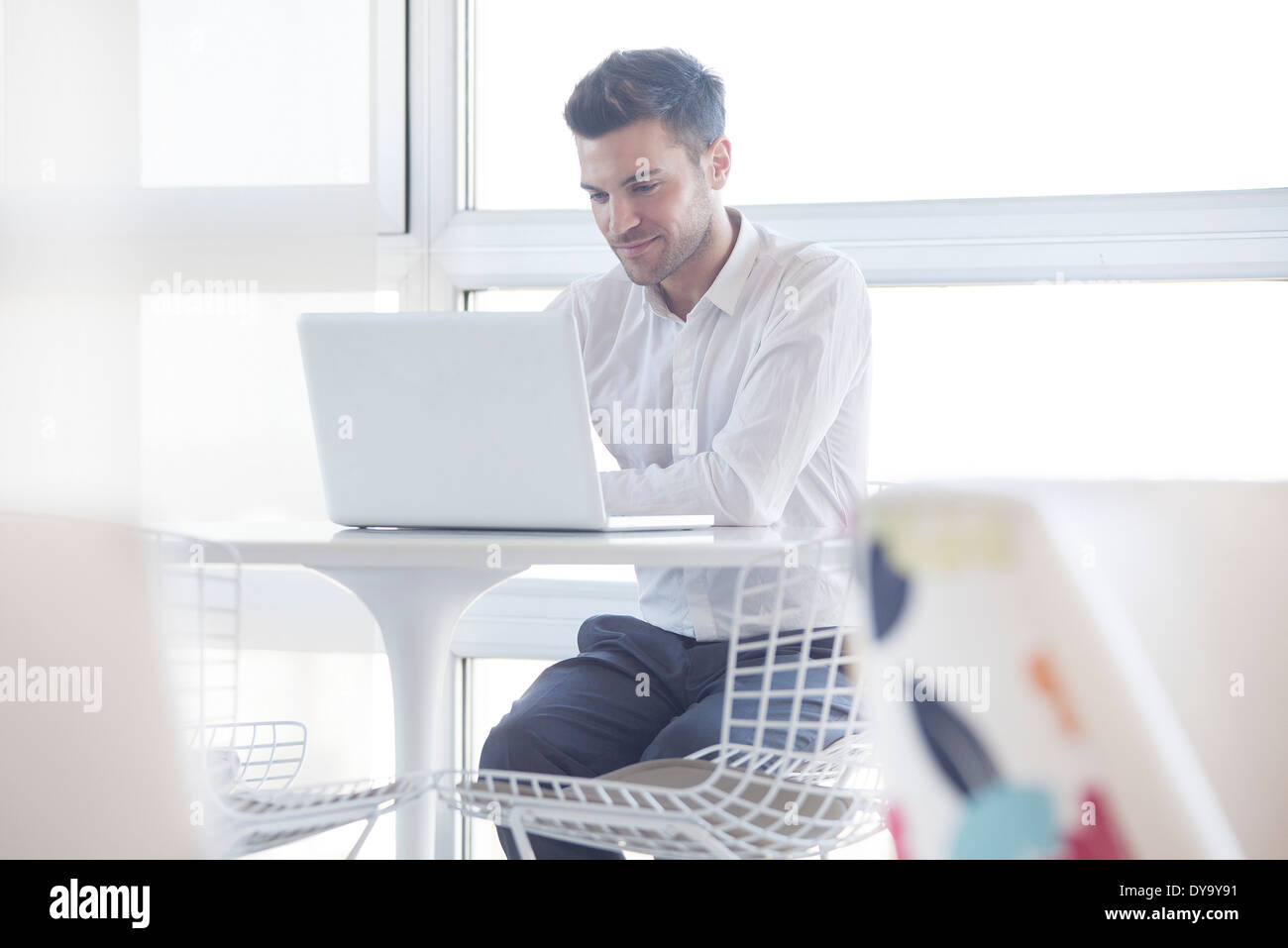 Man using laptop computer in cafe Stock Photo