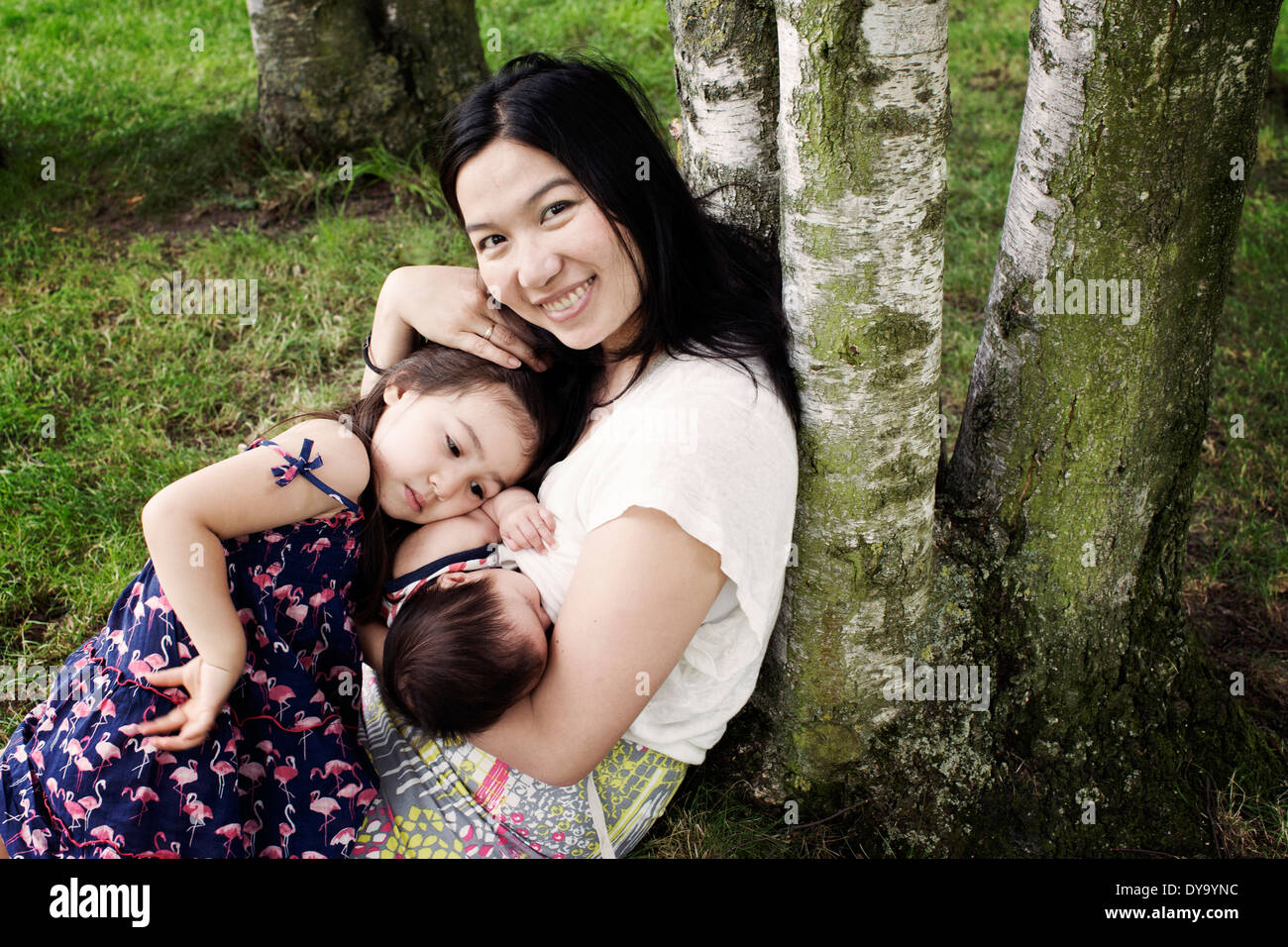 Mother with baby and little girl outdoors Stock Photo