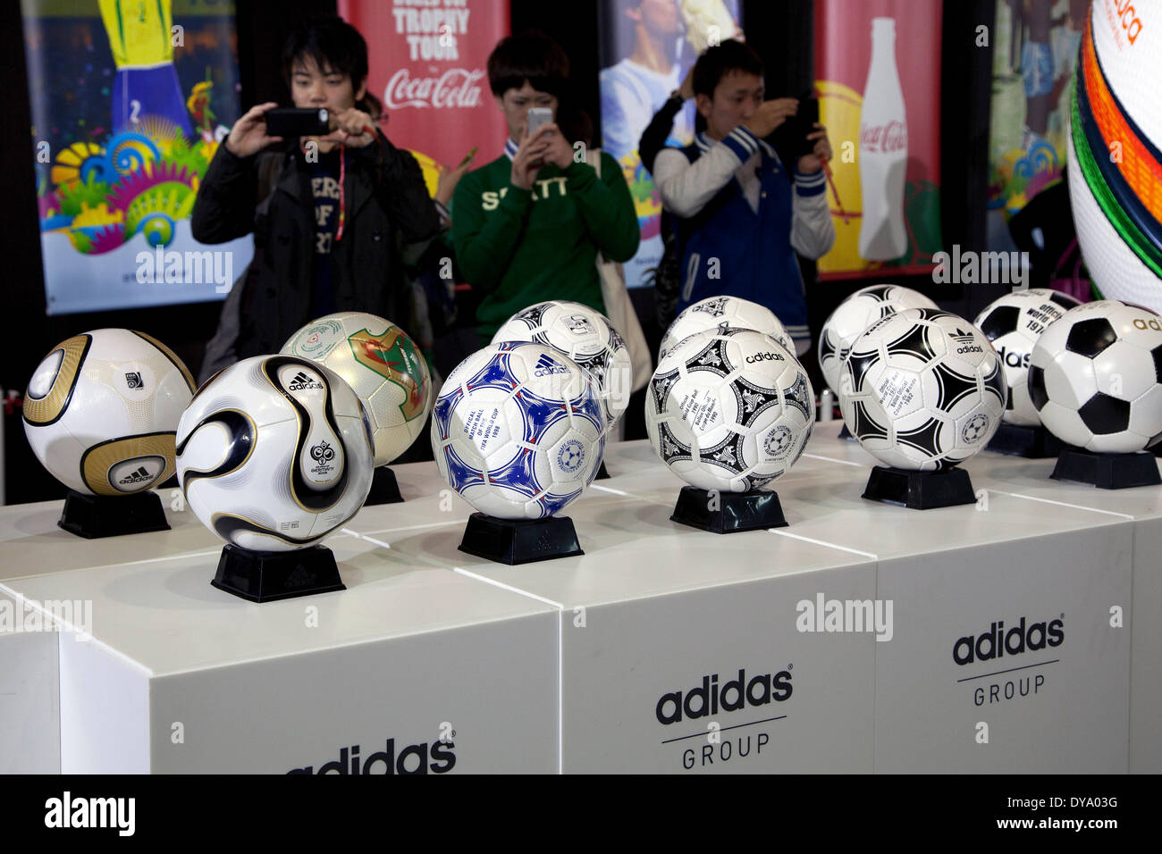 Tokyo, Japan. 11th Apr, 2014. Visitors take pictures of the World Cup soccer balls at the 'Coca Cola Cup Trophy' event in Shibuya, on April 11, 2014. The tour will be release in Tokyo and Rikuzentakata Tohoku on April 12 under the theme 'Tournament Everyone Lead' to send the spirit to the world from the Northeast Japan. Credit:  Rodrigo Reyes Marin/AFLO/Alamy Live News Stock Photo
